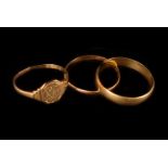 Two 18ct gold rings and a 22ct gold wedding band, one an 18ct gold band, the other a signet ring,