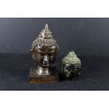 A bronze head of a Buddha, on rectangular plinth, together with a smaller example (2)