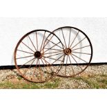 A pair of large cast and wrought iron wagon wheels, approx 118cm diameter