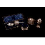 An Edward VII silver Christening set, comprising a napkin and spoon, cased, also a matched cruet set