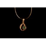 A modern 18ct gold and gem set pendant on chain, the small pierced drop set with an emerald and four