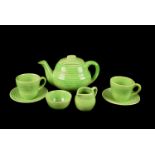 A Chrome Green child's tea service, with circular ridged decoration comprising of teapot, cream,
