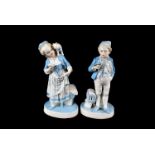 A Pair of Sitzendorf Figures, painted in pale blue and white, of a boy holding a pigeon perched on