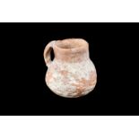A Roman stoneware jug, having single handle, with a few chips, approx. 10cm H