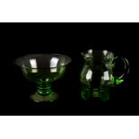 An Art Deco hand blown green glass jug, together with a similar green glass footed bowl (2)