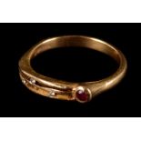 A modern 18ct gold and gem set ring, the pierced line tablet set with three small brilliant cuts