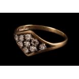 A diamond 9ct gold dress ring, the lozenge shaped setting set with eight small eight cut