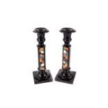 A pair of Pietra Dura candlesticks, both having inlaid design to one side of multiple hardstone in a