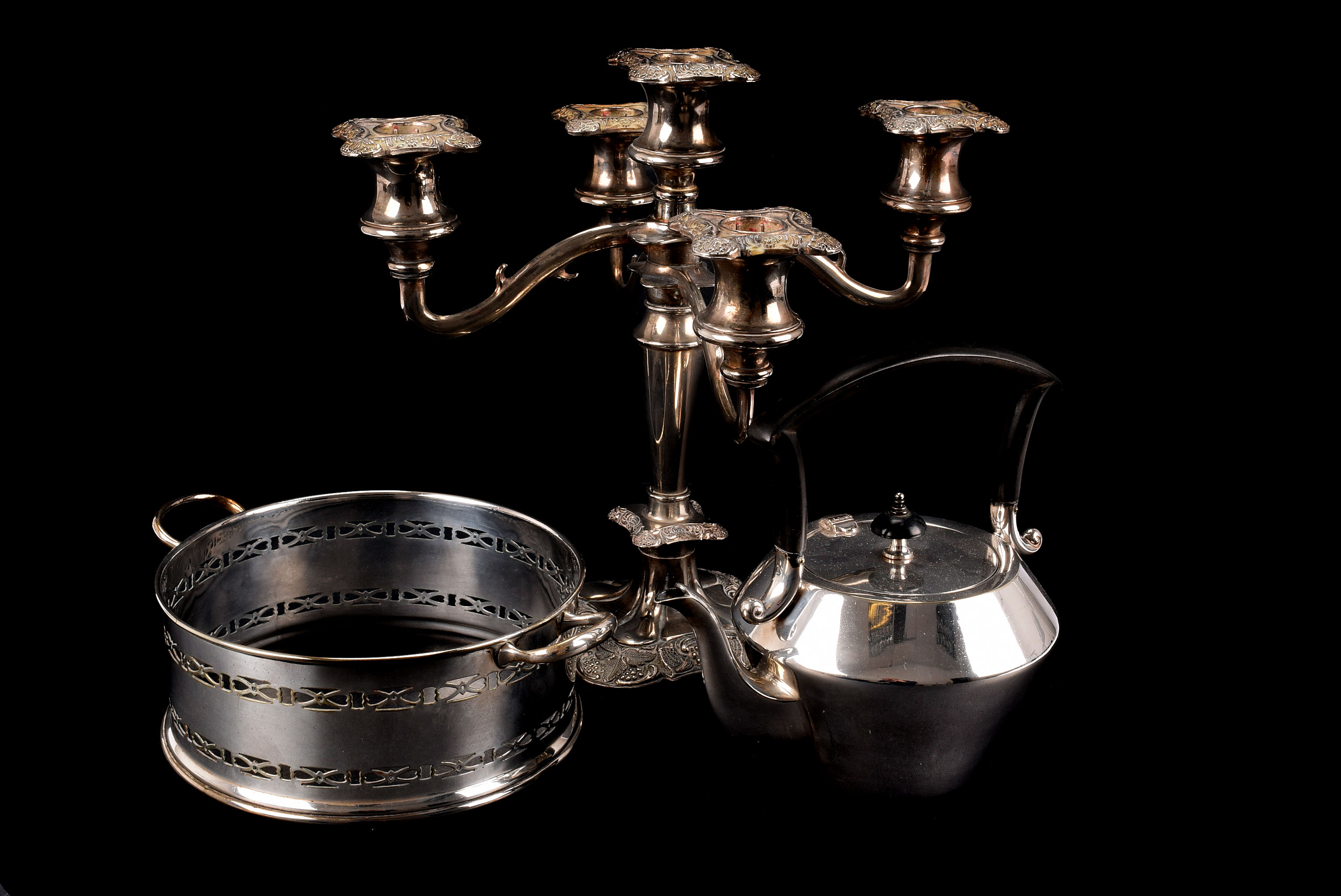 A collection of silver plated items, including a three piece tea set, kettle on stand, egg waiter,