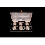 A set of six Art Deco Sterling silver marked miniature tankards, with embossed design of