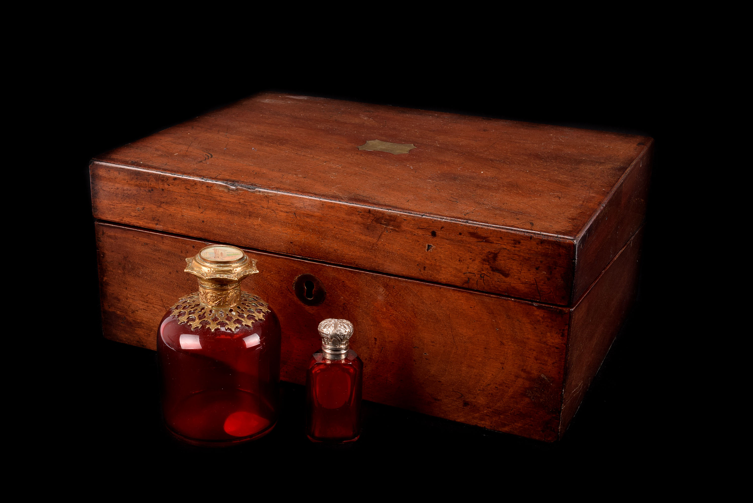 A Victorian cut cranberry glass and silver mounted scent bottle, together with larger French scent