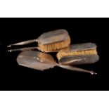 A set of silver mounted dressing table furniture, comprising two pairs of brushes, and a mirror (5)