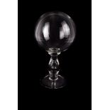 A hand blown clear glass globe on pedestal base. possibly for magnifying light