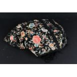 An Edwardian embroided shawl, the black silk, decorated with flowers 125cm square not including