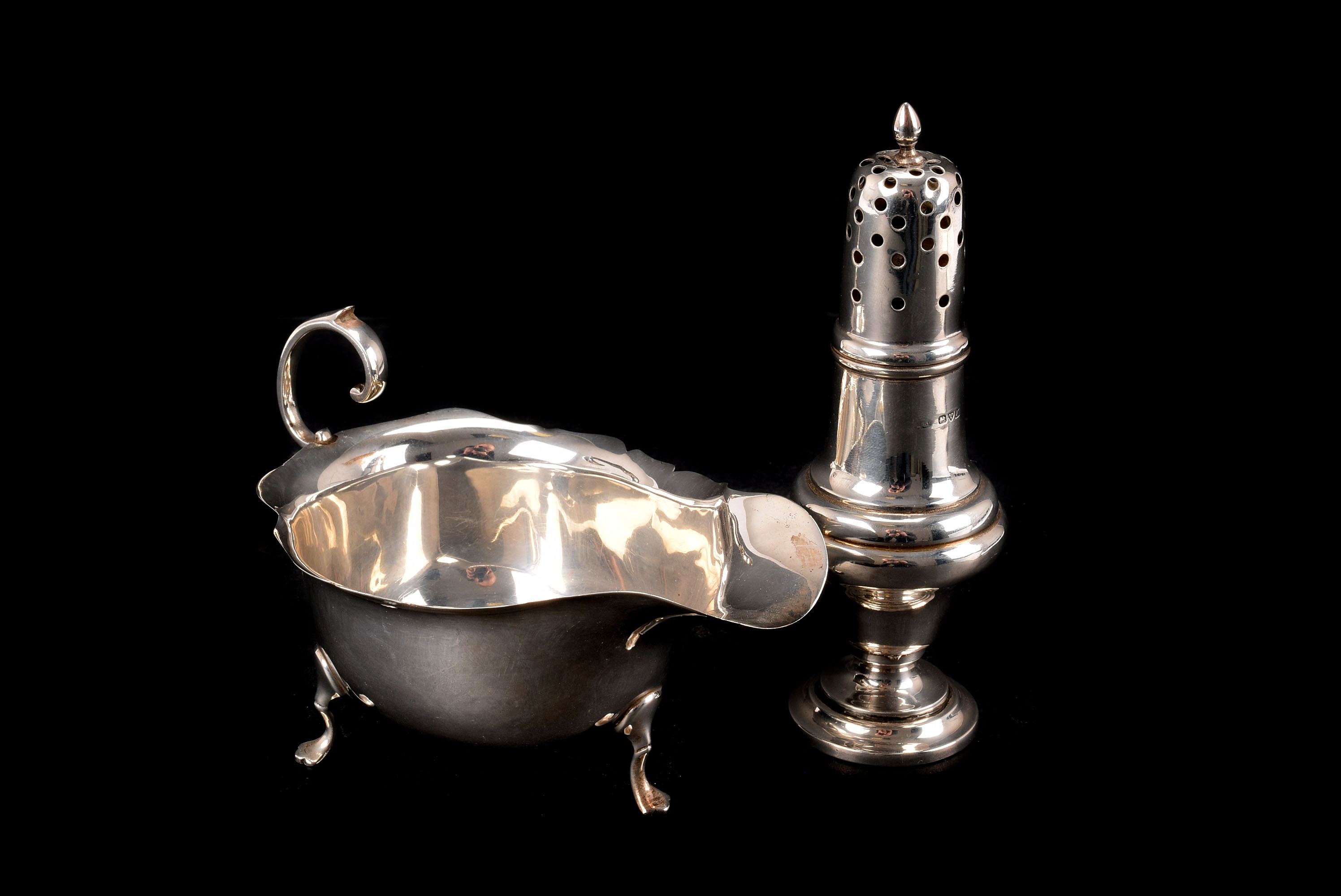 A George V silver sauceboat from Mappin & Webb, together with a George V silver sifter marked