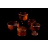 An assortment of five treen items, to include a lidded pot, three goblets and a bowl (5)