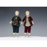 Two bisque headed dolls’ house dolls dressed as young gentlemen, with moulded blonde hair, velvet