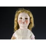 An S.F.B.J. Unis 301 child doll, with brown lashed sleeping eyes, blonde mohair wig, jointed