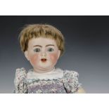 A Kämmer & Reinhardt 126 baby doll, with blue sleeping eyes, brown hair wig, bent-limbed composition