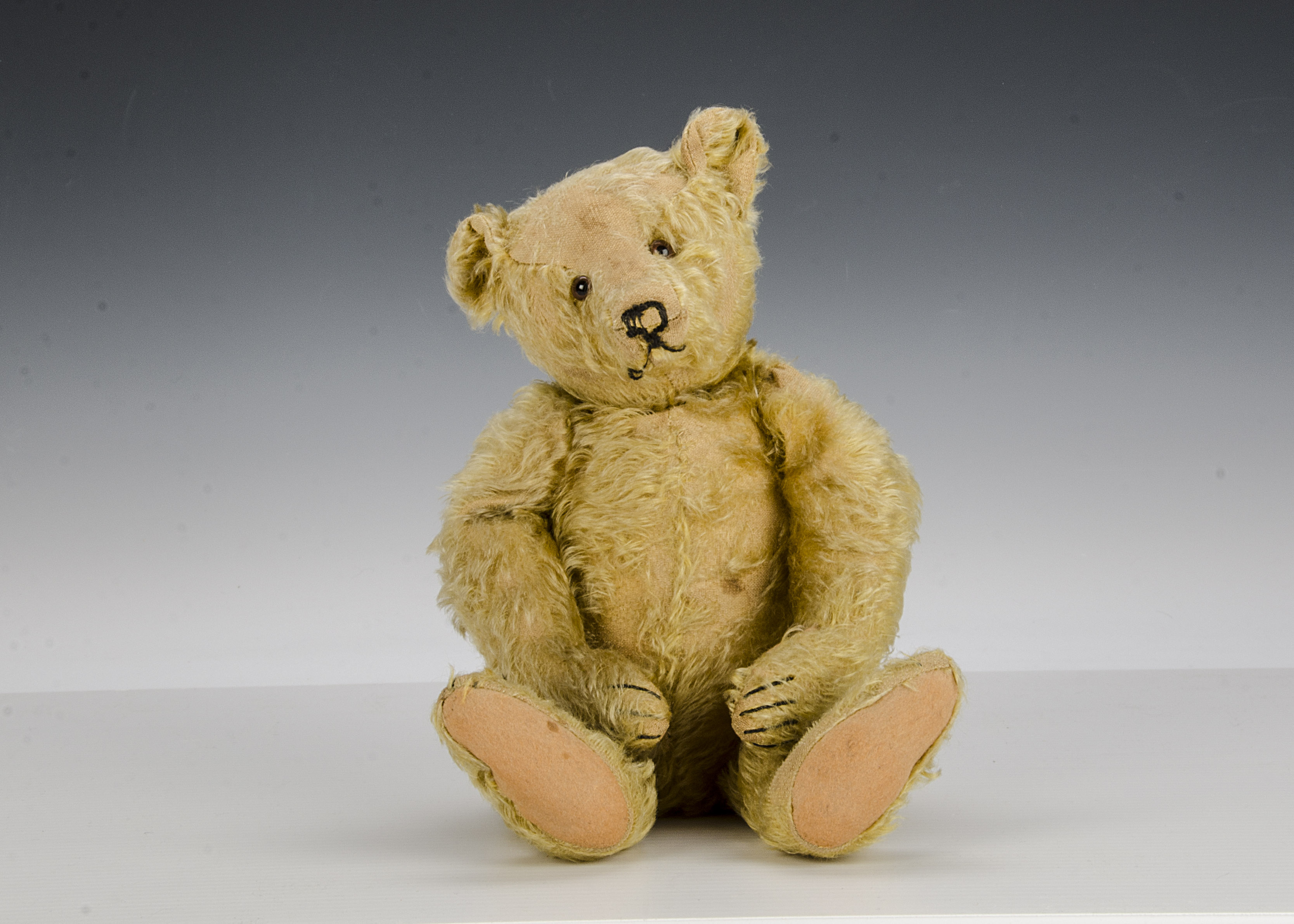 A Steiff 1930s teddy bear, with golden mohair, clear and black glass eyes with brown backs,