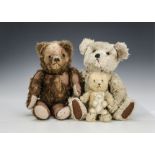 Four teddy bears: a British brown wool plush pyjama case with orange and black glass eyes and zipper