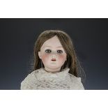 An Ernst Heubach 250 child doll, with lashed blue eyes, brown hair wig, jointed composition body,