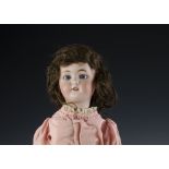 A Simon & Halbig 1078 child doll, with blue sleeping eyes, pierced ears, brown mohair wig, jointed