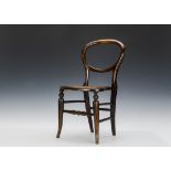 A late 19th century child’s balloon back chair, mahogany with cane seat - 231?2in. (59.5cm.) high (