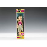 A Pedigree Sindy en Vacances, with blonde hair, pink swim suit and wrap-round floral skirt, in