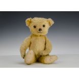 A Dean’s Rag Book Co. mouse eared teddy bear 1950s, with golden mohair, orange and black glass eyes,