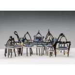 Twelve pieces of late 19th century wishbone furniture, painted brown, upholstered in blue with white