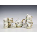 A Continental child’s tea set, for six, painted with snowy house scene and gold handles