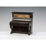 A Waltershausen dolls’ house upright piano, with working keys and cupboard below - 41?2in. (11.5cm.)