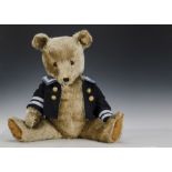 A large Chiltern Hugmee Teddy Bear, 1950s, with blonde mohair, orange and black glass eyes, black