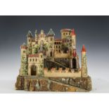 A German paper on wood toy castle, with cork ramparts, two layered with elaborate cut out two-