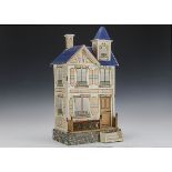 A Gottschalk blue roof dolls’ house, in the French style, wood covered in printed paper with brick