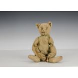 An early Steiff teddy bear, circa 1909, with blonde mohair, pronounce muzzle, black stitching,