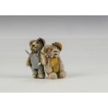 Two unusual promotional Schuco miniature dressed teddy bears 1950s, with beige mohair, black metal