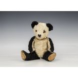 A Chiltern Hugmee artificial silk Panda 1950s, with black and white plush, orange and black glass