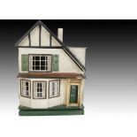 A Tri-ang dolls’ house late 1930s, with textured cream painted walls, part timbered to eaves,