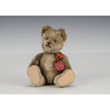 A Schuco Tricky yes/no teddy bear 1950s, with beige mohair, clear and black glass eyes with brown