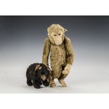 A British brown mohair monkey 1920s, with felt face, ears, hand and feet, clear and black glass eyes