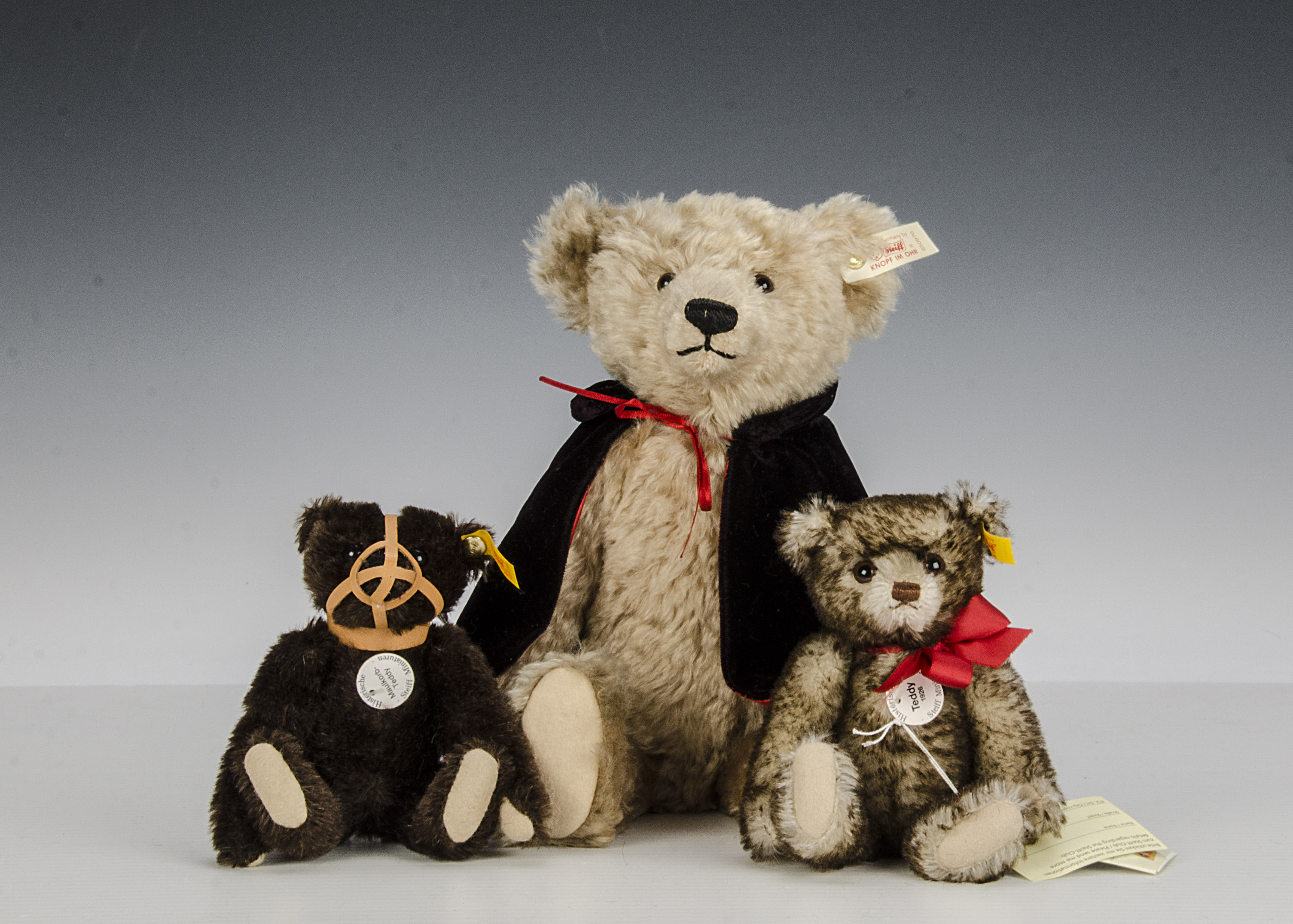 A Steiff Limited Edition LiebhaBear, 290 of 2550, 1996 (missing most of his clothes); and two yellow