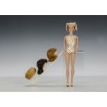 A Fashion Queen Barbie doll, with original gold and white swim costume, hat and three wigs on stand,