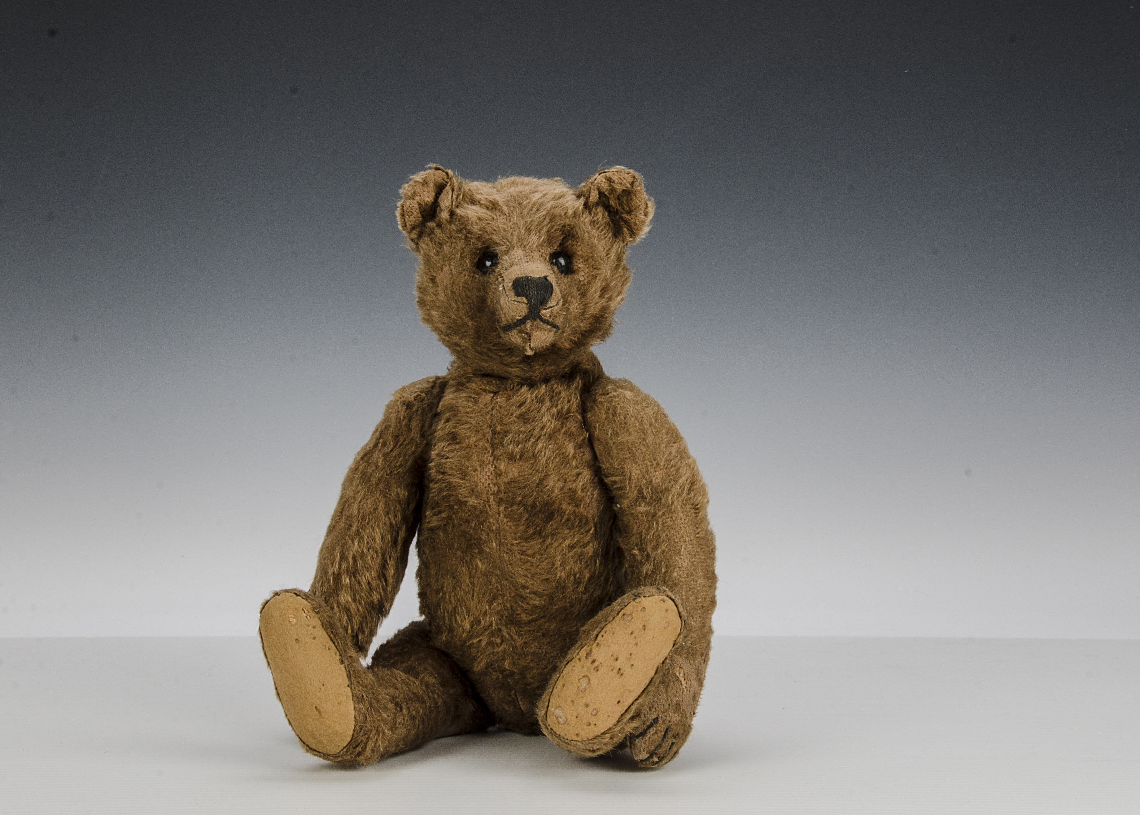 A rare early Steiff brown mohair teddy bear, circa 1910, with black boot button eyes, pronounced