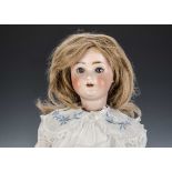 A Schoenau & Hoffmeister 1909 child doll, with brown lashed sleeping eyes, brown hair wig, jointed