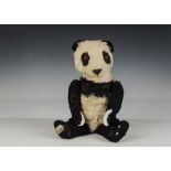 A Merrythought Panda teddy bear, circa 1941, with black and white mohair, inset wool plush muzzle,