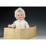 A large Armand Marseille composition baby in original box, with blue lashed sleeping eyes, bent-