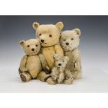 Four post-war Chiltern Hugmee teddy bears, two with blonde mohair, two with golden mohair, orange ad