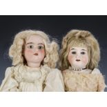 Two bisque headed dolls: a Cuno & Otto Dressel 93-2 shoulder head doll on kid body - 14in. (35.5cm.)